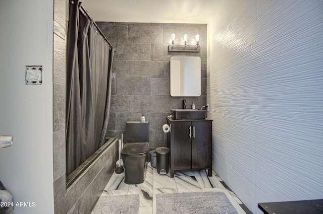 full bathroom with shower / bath combo with shower curtain, vanity, tile walls, and toilet