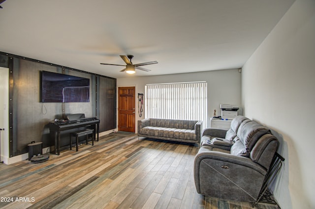 living room featuring ceiling fan and hardwood / wood-style floors