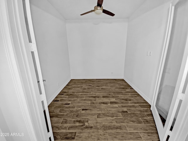 unfurnished room with wood tiled floor, baseboards, and a ceiling fan