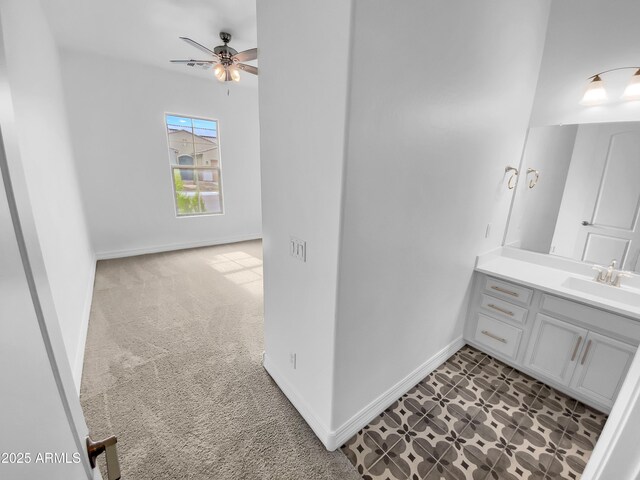 bathroom featuring ceiling fan, vanity, and baseboards