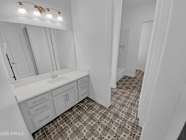 full bathroom with baseboards, vanity, and tile patterned floors