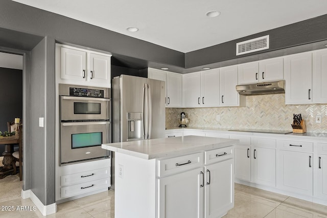 kitchen with white cabinetry, appliances with stainless steel finishes, and a kitchen island