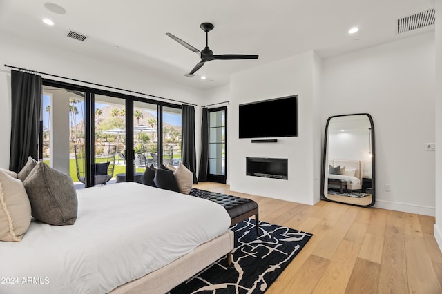 bedroom with ceiling fan, light hardwood / wood-style flooring, and access to outside