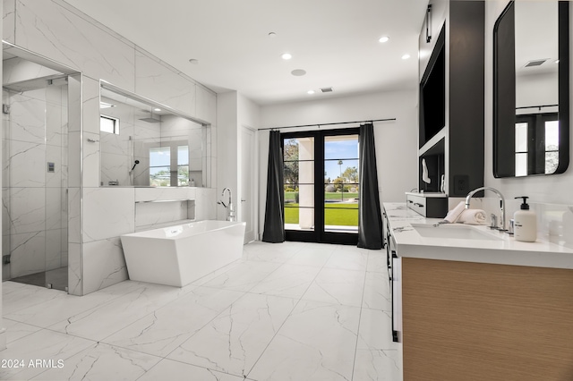 bathroom featuring vanity, french doors, and independent shower and bath