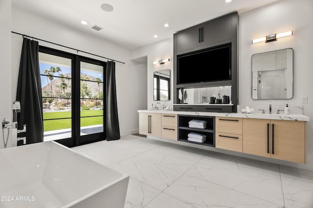 bathroom with a tub and vanity