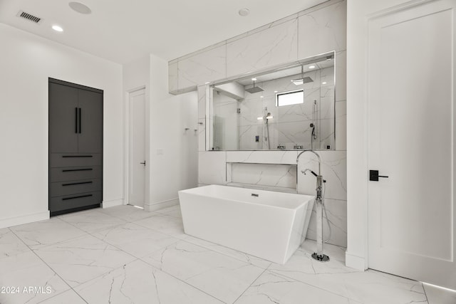 bathroom featuring shower with separate bathtub