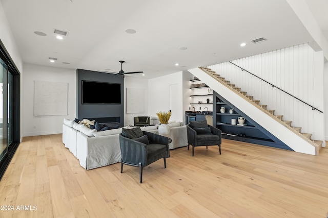 living room featuring light hardwood / wood-style floors and ceiling fan