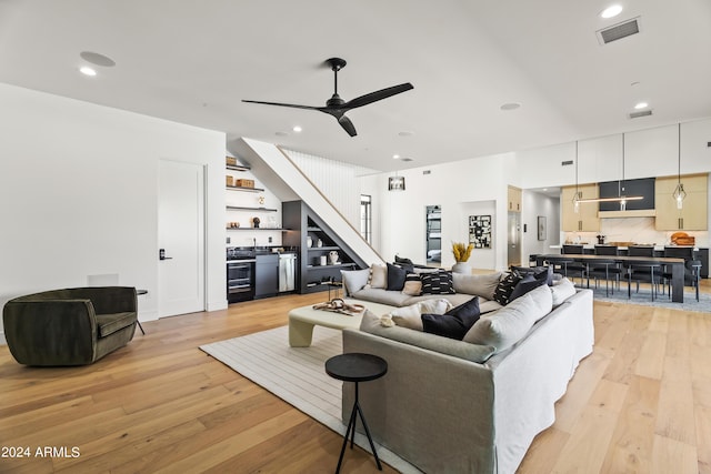 living room with ceiling fan and light hardwood / wood-style flooring