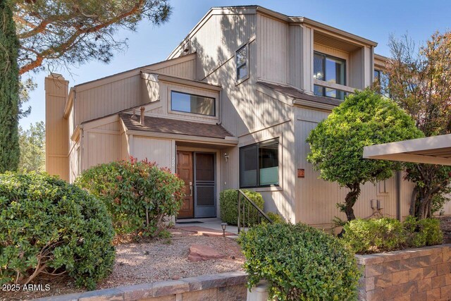 1380 Vista Montana Rd Unit 22, Sedona, AZ 86336 - view of front facade featuring a chimney and a shingled roof