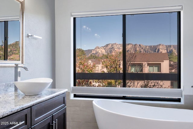 1380 Vista Montana Rd Unit 22, Sedona, AZ 86336 - full bath featuring vanity, a freestanding tub, a mountain view, and a textured wall