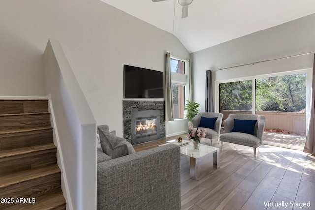 1380 Vista Montana Rd Unit 22, Sedona, AZ 86336 - living area featuring lofted ceiling, ceiling fan, wood finished floors, a glass covered fireplace, and stairs