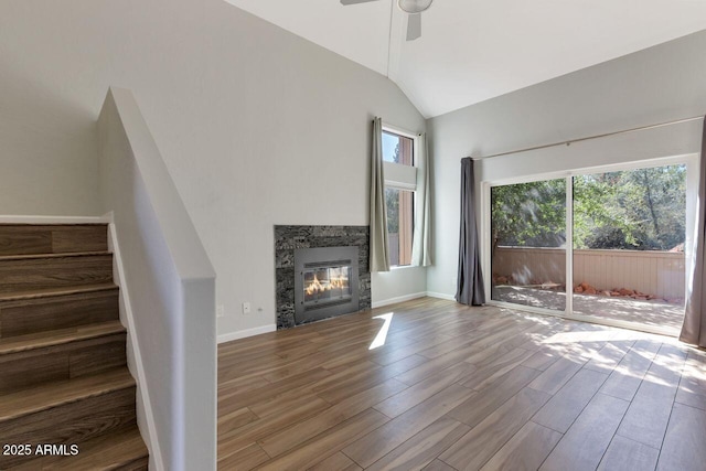 1380 Vista Montana Rd Unit 22, Sedona, AZ 86336 - unfurnished living room featuring healthy amount of natural light, wood finished floors, lofted ceiling, a ceiling fan, and stairway