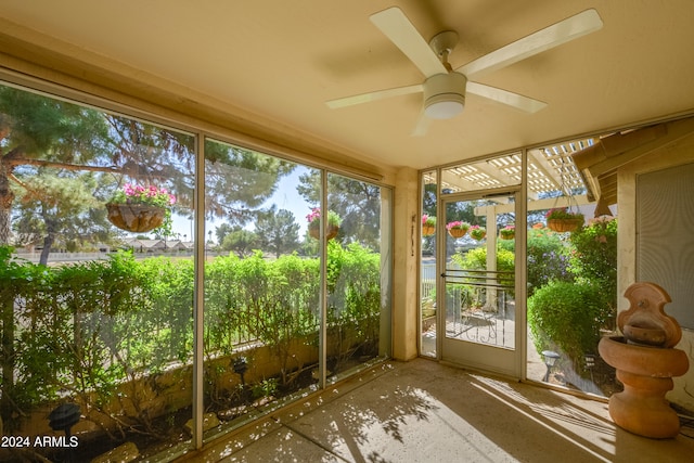 unfurnished sunroom featuring a wealth of natural light and ceiling fan