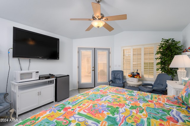 bedroom with french doors, vaulted ceiling, stainless steel refrigerator, and ceiling fan