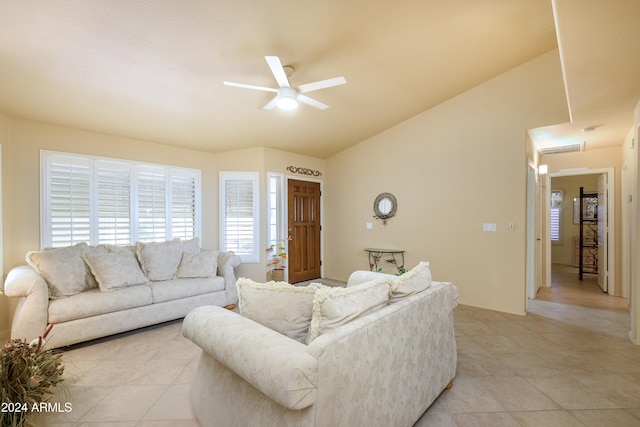 living room featuring light tile patterned floors, vaulted ceiling, and ceiling fan