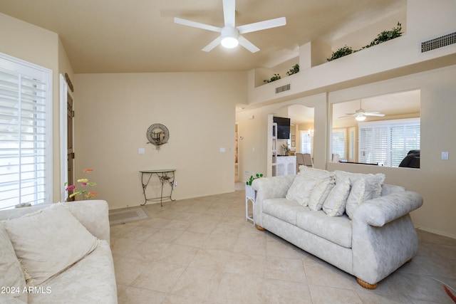 living room with high vaulted ceiling and ceiling fan