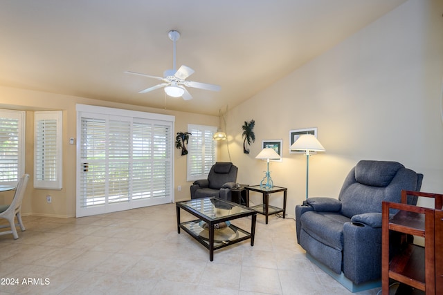 tiled living room featuring ceiling fan and vaulted ceiling