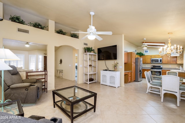 tiled living room featuring washer / clothes dryer, a chandelier, high vaulted ceiling, and sink