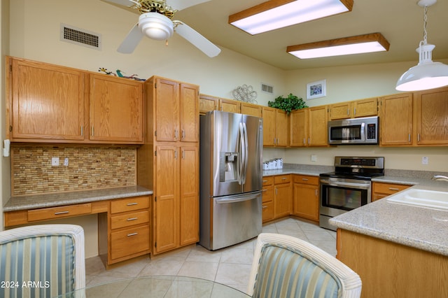 kitchen with lofted ceiling, stainless steel appliances, sink, pendant lighting, and light tile patterned floors