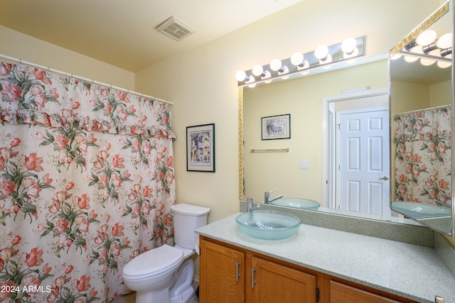 bathroom featuring vanity, toilet, and walk in shower