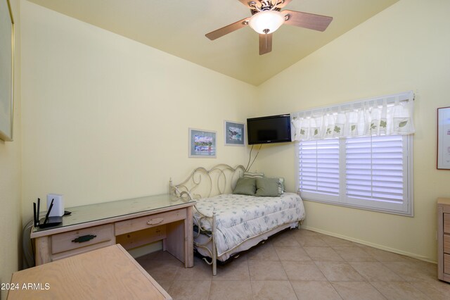 tiled bedroom with vaulted ceiling and ceiling fan