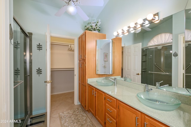 bathroom featuring lofted ceiling, ceiling fan, a shower with shower door, vanity, and tile patterned floors