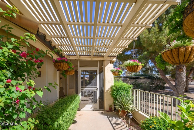 doorway to property with a pergola