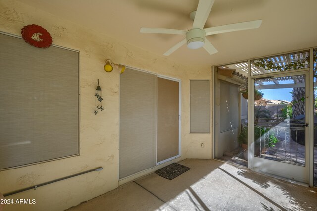 property entrance with ceiling fan