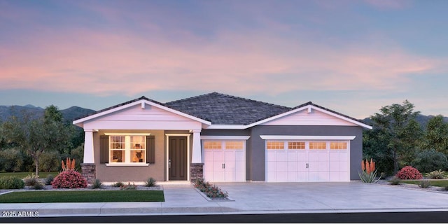 view of front of house with stucco siding, concrete driveway, and a garage