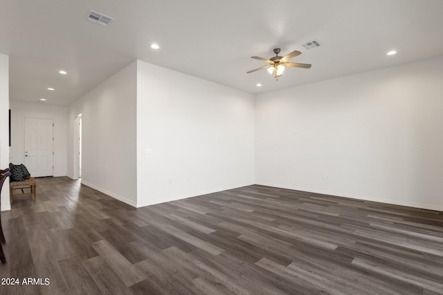 empty room with dark hardwood / wood-style flooring and ceiling fan