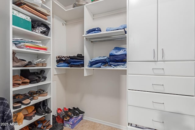 spacious closet featuring light tile patterned flooring