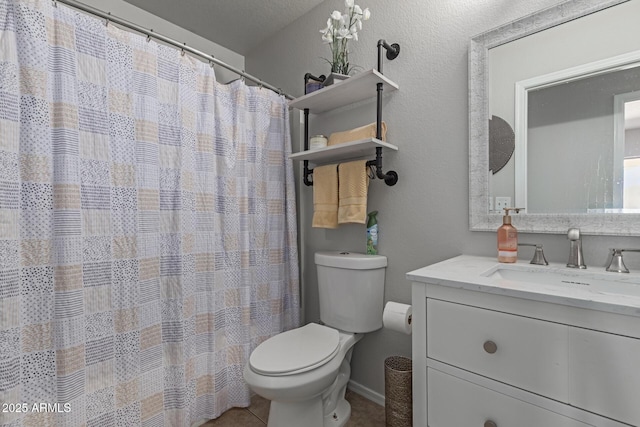 bathroom featuring tile patterned floors, a textured ceiling, toilet, and vanity