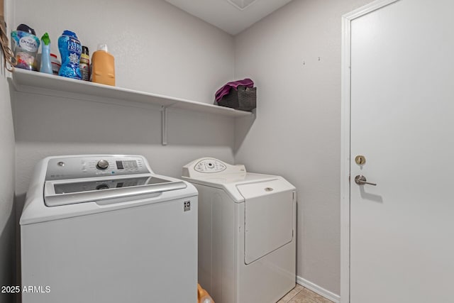 laundry area featuring independent washer and dryer and light tile patterned floors