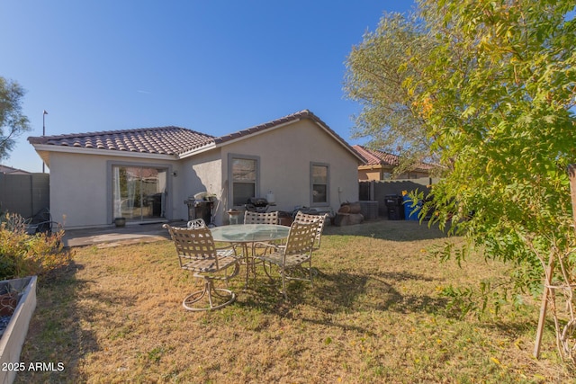 back of property featuring a patio area and a yard