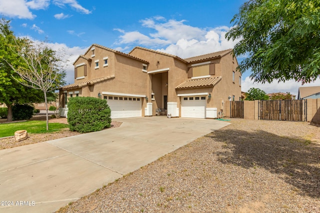 mediterranean / spanish-style home with a garage