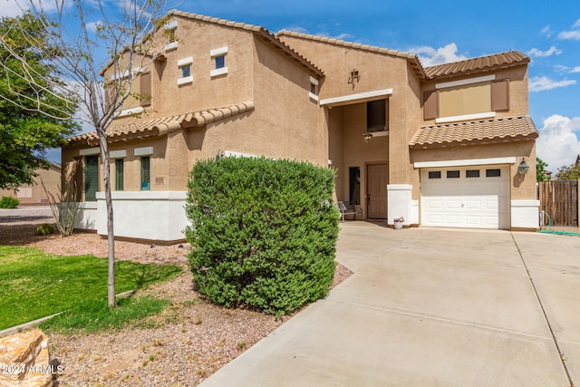 mediterranean / spanish-style home featuring a garage