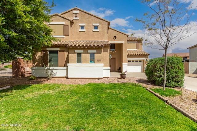 mediterranean / spanish home featuring a garage and a front yard