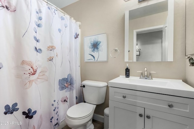 bathroom with vanity, toilet, and walk in shower