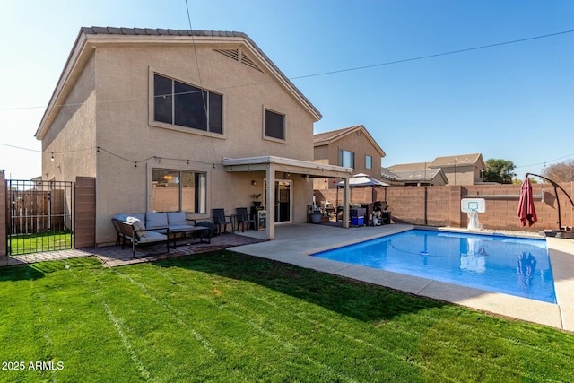 back of house with an outdoor living space, a lawn, a fenced in pool, and a patio area