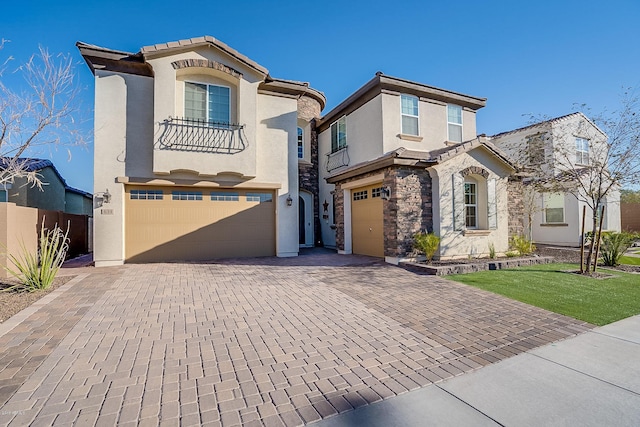 mediterranean / spanish house featuring a garage and a front lawn