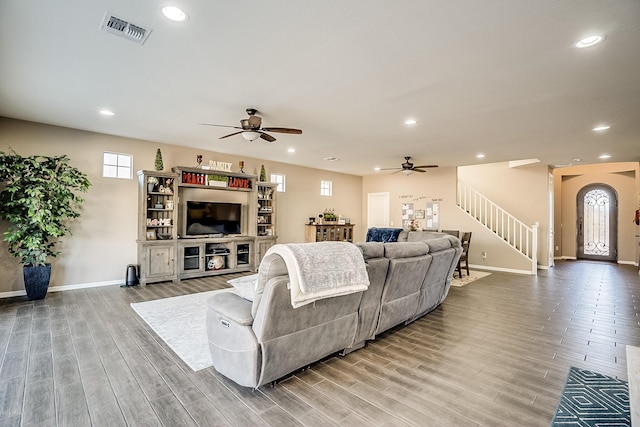 living room featuring wood-type flooring and ceiling fan