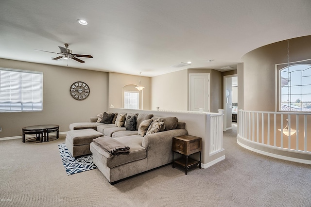 carpeted living room with a wealth of natural light and ceiling fan