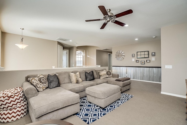 living room with ceiling fan and carpet floors