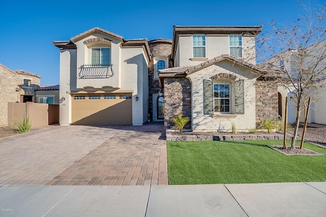 mediterranean / spanish-style house with a front yard and a garage