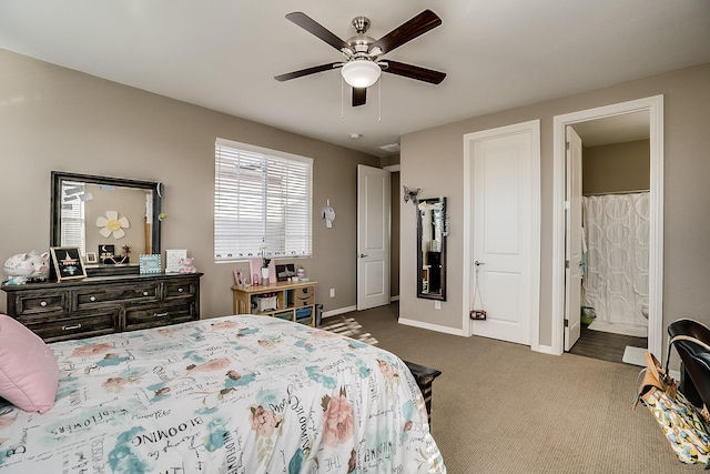 bedroom featuring dark carpet, ensuite bath, and ceiling fan