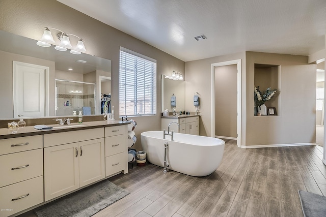 bathroom with vanity, hardwood / wood-style flooring, and separate shower and tub