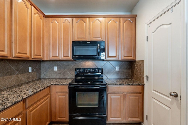 kitchen with black appliances, decorative backsplash, and dark stone counters