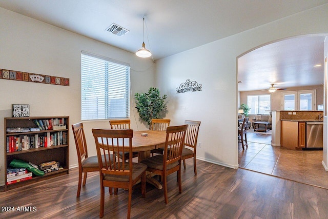 dining room with dark hardwood / wood-style flooring and ceiling fan