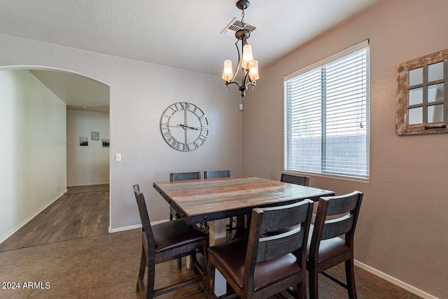 dining room featuring dark wood-type flooring and a notable chandelier