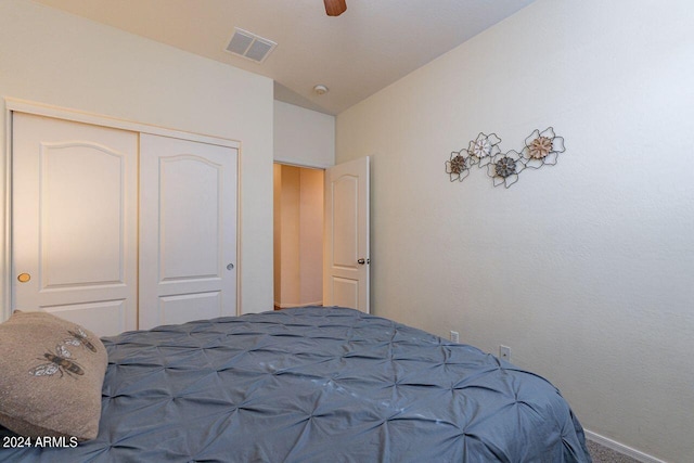 bedroom with lofted ceiling, a closet, and ceiling fan